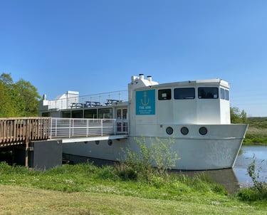 The ark northampton, a large white boat on the river nene, on a sunny summer day