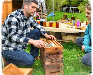 a man and woman sitting on a picnic table