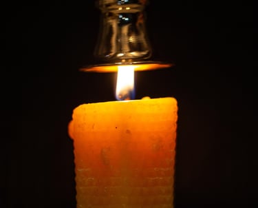 a candle with a candle lite up in the dark