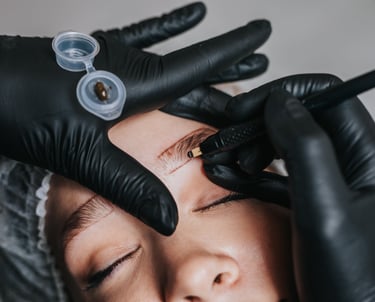 professional performing permanent eyebrow on client