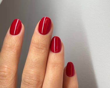 Image of perfectly manicured hands with bright red nails