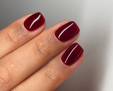 Image of perfectly manicured hands with dark red nails