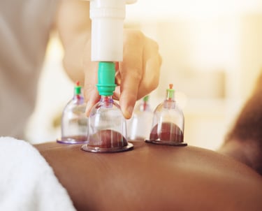 a person is getting cupping as part of a remedial massage