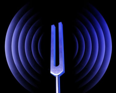 Tuning fork with sound waves in the background