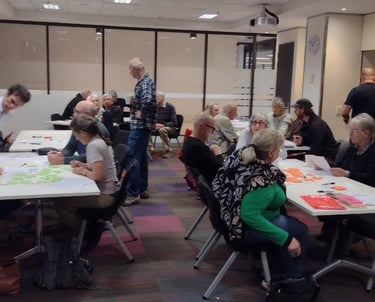 Groups of people at tables in a room