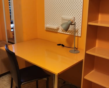 Habitación con amplio escritorio y estantería