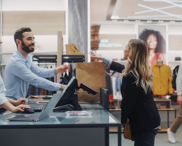 a man and woman serving a customer in a store