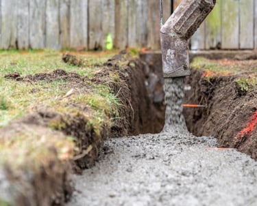 a concrete slab being poured into a concrete foundation