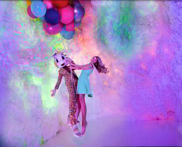 a girl in a dress holding a balloon