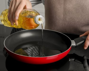 woman pouring oil in a pan on the stove
