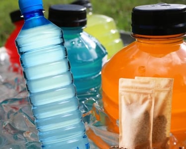 a variety of different colored bottles of water and energy drinks