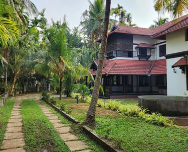 Exterior image of Poomuttath Illam with its greenery and pathway