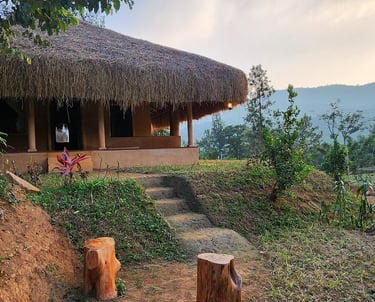 A mud house in Nelli looking at brahmagiri mountains