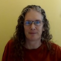 a woman with glasses and a red shirt