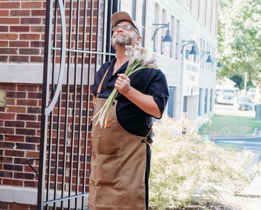a man in a apron and hat with a canelle
