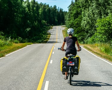 Femme qui voyage à vélo sur une belle route