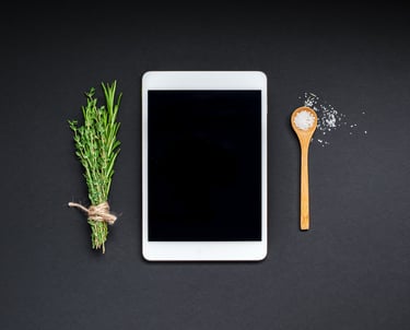 a tablet with a wooden spoon and a wooden spoon next to a wooden spoon