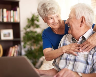 a man and woman sitting on a couch in a living room