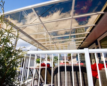 Patio Cover over a deck with tinted see-through panels.