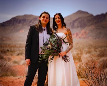 a man and woman standing in the desert