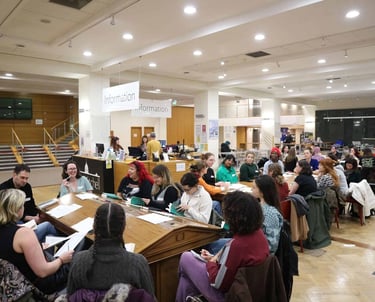Participants engaged in a lively book club meeting in a community space, illustrating the communal a