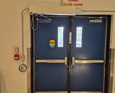 A school door has a door operator installed