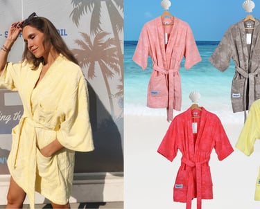 Woman relaxing outdoors wearing Mermaids Club cotton beach robes after swimming.