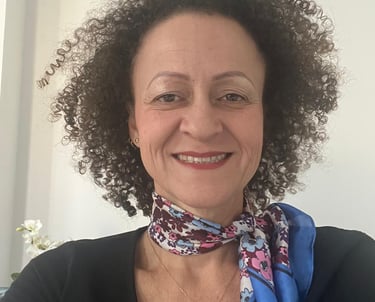a woman with curly hair and a scarf around her neck