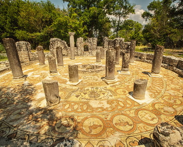 a circular stone mosaic tile flooring with a circular mosaic design