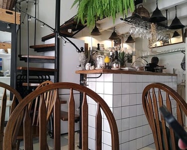 a restaurant with a table and chairs and a staircase