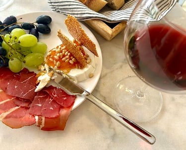 a plate of food and wine glasses on a table