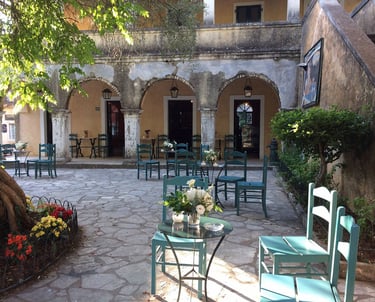 a patio with chairs and tables in a courtyard