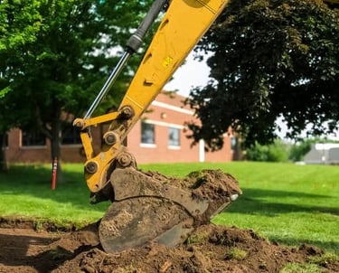 excavator breaking up land