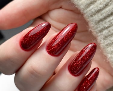 a person's hand holding a red manicured manicured manicure