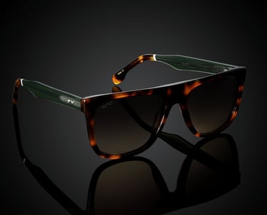 Tortoiseshell sunglasses with green accents and brown lenses, displayed on a reflective black background for e-commerce photo
