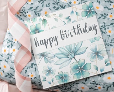 Teal flowers birthday tag on top of the present