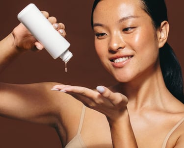 a woman holding a bottle of liquid in her hand
