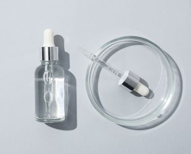 a small glass bottle of liquid with a small pill pill