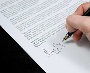 A person holding a pen and Singing a document
