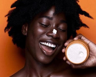 a black woman with a skin care product. credit from pinterest