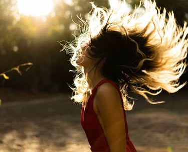 Young woman dancing after an acupuncture wellness appointment in Glenwood Springs, CO