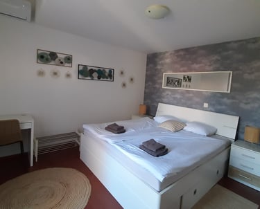 Bright bedroom with king-size bed in family apartment near Pula