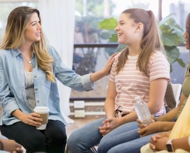 a group of people sitting in a circle with coffee cups