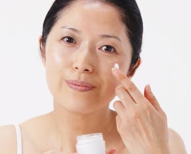 woman moisturizing her face