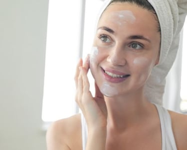 woman putting sunscreen on her face