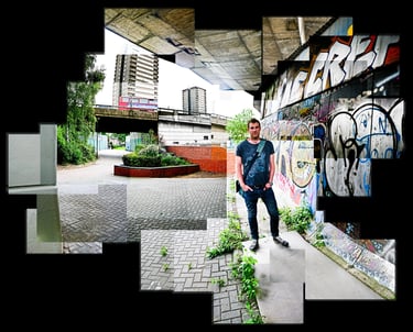 A joiner of a man standing in an urban environment with a graffiti sprayed wall over his shoulder
