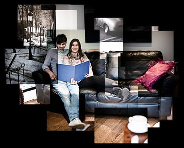 A joiner of a happy couple sat reading a book on a black leather sofa