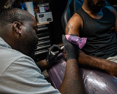 Andre doing a floral cover up tattoo