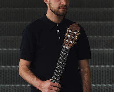 Classical guitarist Filip Babic standing with the guitar casual