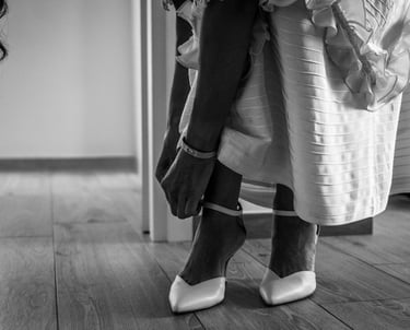 a woman in a dress and heels is standing in a room